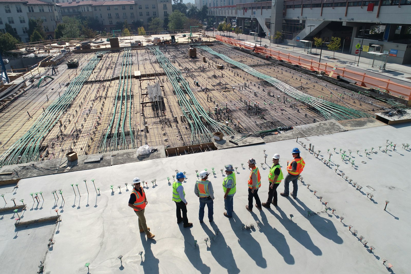 Construction workers surveying a large worksite
