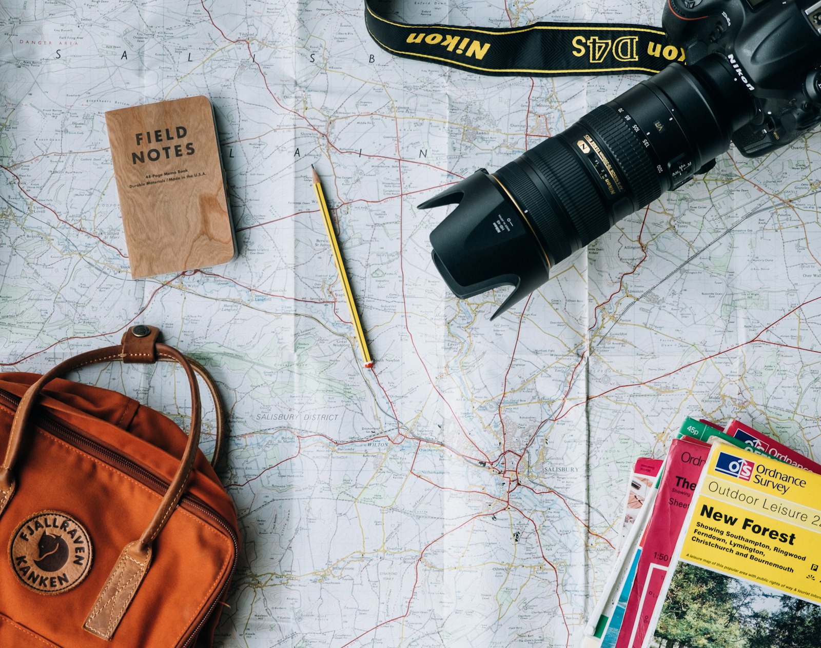 Map, camera and backpack laid out for planning a journey abroad