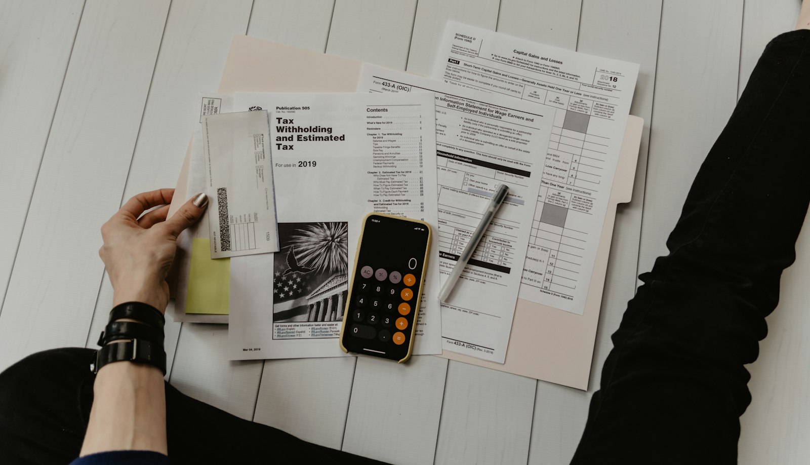 Calculator, tax papers and pen on a desk