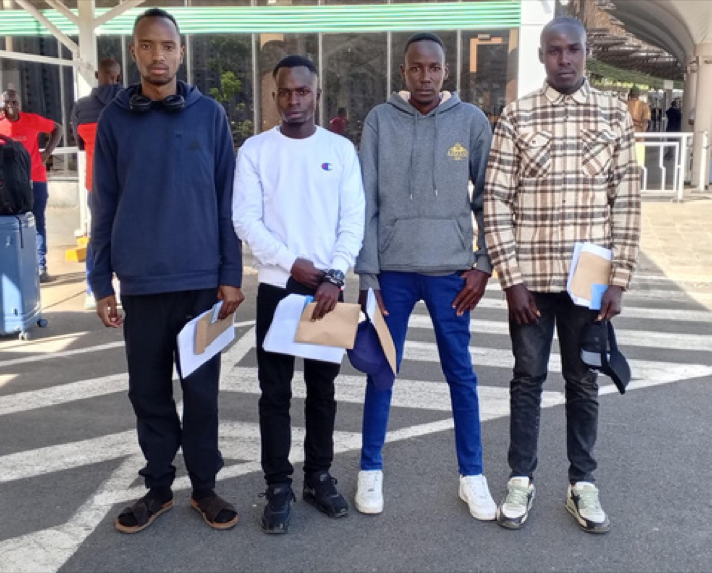 Candidates at the airport with travel documents, ready for mobilisation