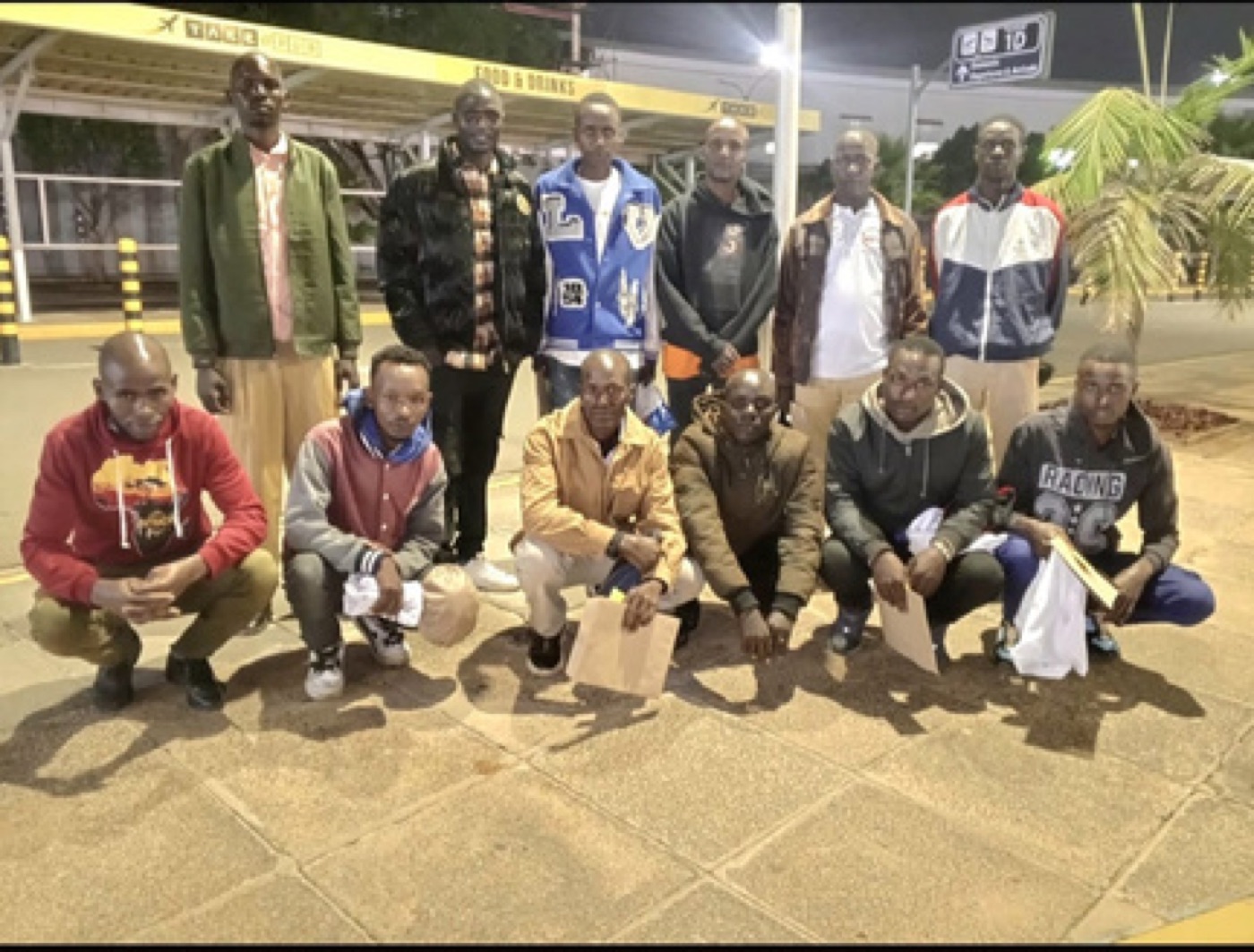A departing cohort assembled at the terminal at night
